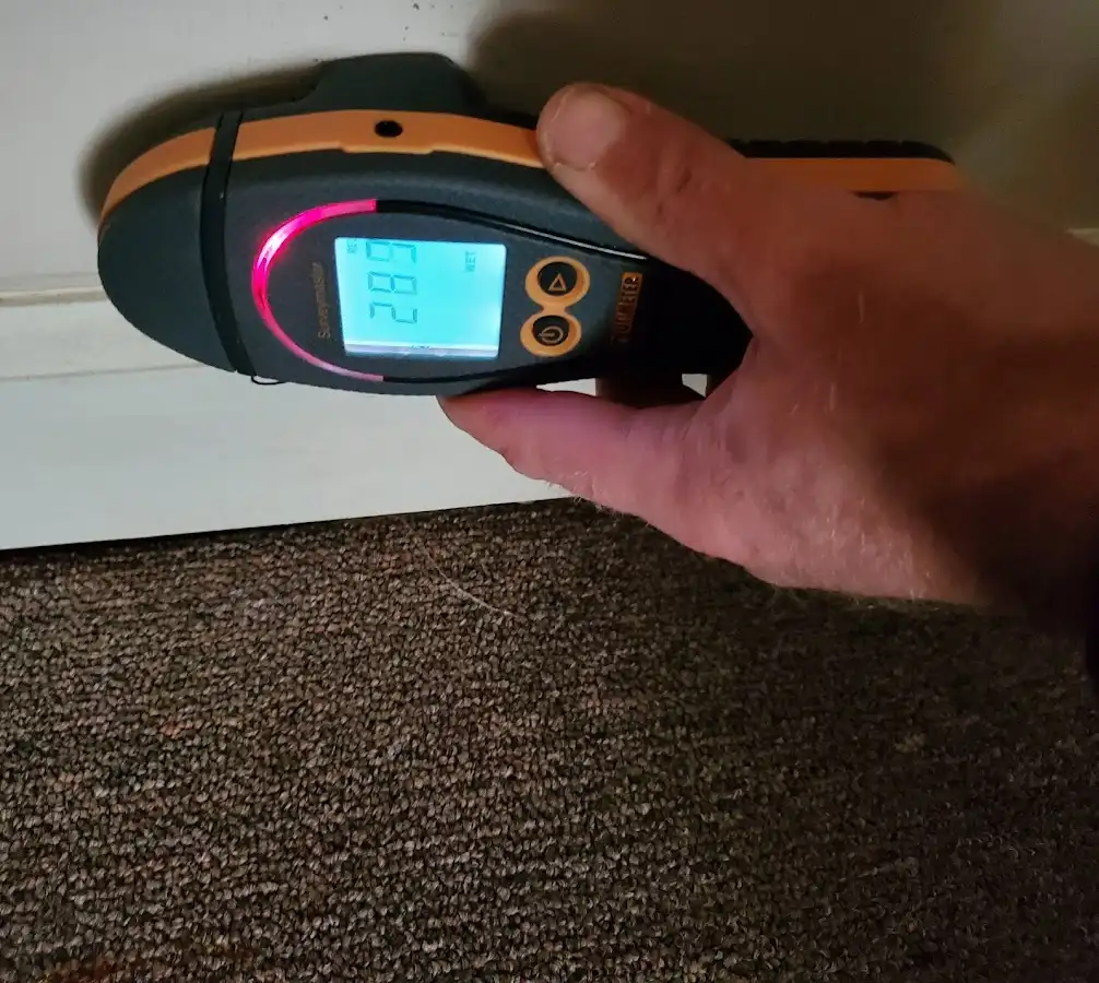 Moisture detection at baseboard during Storm Damage Restoration in New Hanover